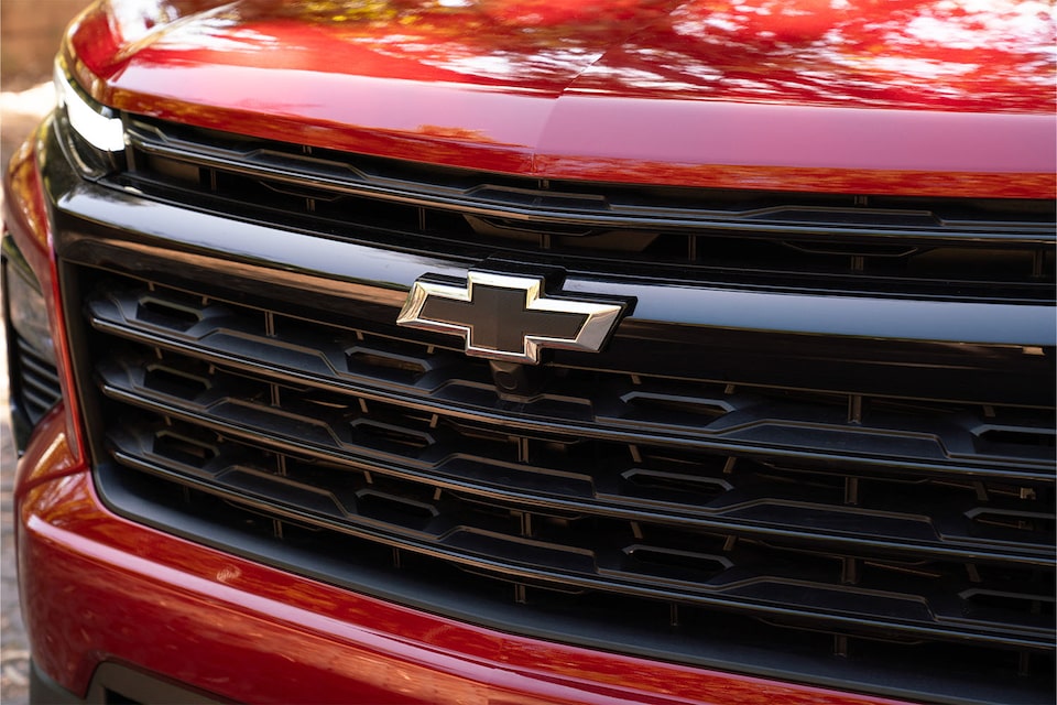 Parrilla frontal y logo Chevrolet en SUV Traverse 2025 color rojo, destacando diseño robusto y moderno